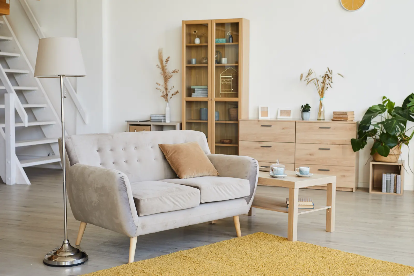 Living room with a sofa, rug, and hardwood floors adding value to a house